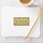 Merry Christmas Modern Gold Return Address Label<br><div class="desc">Holiday return address labels feature modern white script "Merry Christmas" writing with festive holly branches and berry accents. The antique gold background colour can be customised.</div>