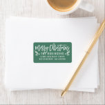 Merry Christmas Modern Green Return Address Label<br><div class="desc">Holiday return address labels feature modern white script "Merry Christmas" writing with festive holly branches and berry accents. The pine green background colour can be customised.</div>