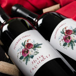 Merry Christmas red and green floral family name Wine Label<br><div class="desc">Celebrate this Christmas with an elegant personalised labelled wine with your family name!             Easy to customise featuring a traditional fir branches and winter peonies seasonal bouquet, </div>