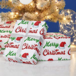 Merry Christmas Santa Hat red green script Wrapping Paper<br><div class="desc">Wrapping paper with Merry Christmas in 3D green and red text and a Santa Claus hat. Available in several styles and sizes.</div>
