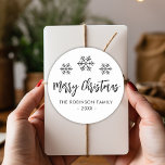 Merry Christmas Script Black White Snowflake Classic Round Sticker<br><div class="desc">Modern Script Black and White "Merry Christmas" Calligraphy Script Christmas Holiday Round Sticker. Features cute snowflakes (snowy) background,  family name and year. Great for Mailing Accessories Envelope Seals and Gift Stickers.</div>