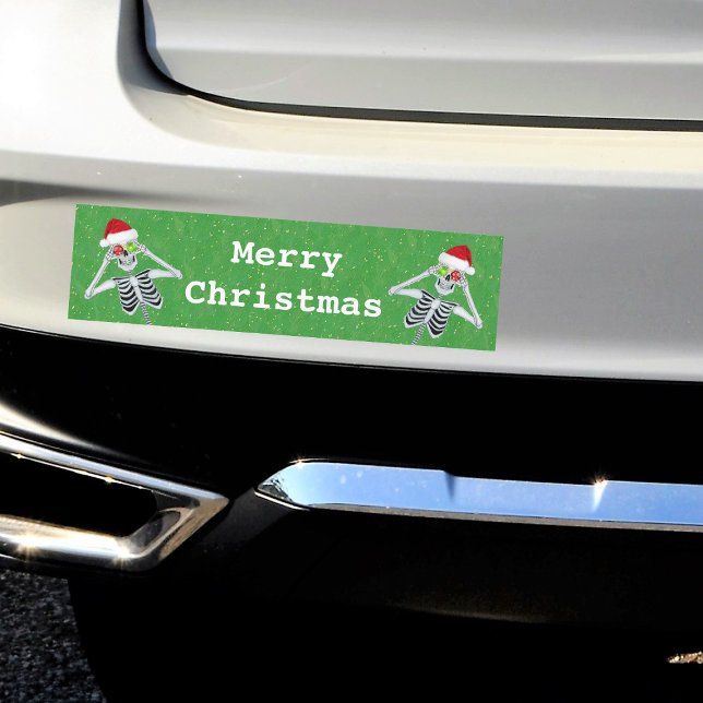 Merry Christmas Skeletons Ornament Eyes Green Bumper Sticker (Silly skeletons ornament eyes red Santa hats on green Merry Christmas bumper sticker.)