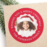 Merry Christmas wavy border red photo Classic Round Sticker<br><div class="desc">Round,  red stickers featuring customisable text "Wishing you a merry Christmas" and your name around your photo inside a wavy border.</div>