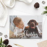 Merry Christmas White Modern Brushed Script Photo Holiday Card<br><div class="desc">Minimalist holiday photo card features your favorite photo from the year with a "Merry Christmas" overlay design in white brushed script writing along with simple text you can personalize with your name or family and the year. A pattern of abstract dots on a neutral beige / tan background (can be...</div>