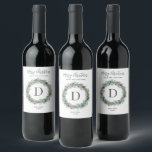 Merry Christmas Winter Greenery Monogram Wreath Wine Label<br><div class="desc">Elegant "Merry Christmas" holiday homemade wine label design features a rustic chic round wreath of winter watercolor greenery framing the family's last name monogram initial letter. Personalise the modern green and charcoal grey wording with a custom greeting, last name, the type of wine, and the year. Clean white background colour...</div>