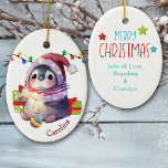 Merry Penguin Kids Christmas Ceramic Ornament<br><div class="desc">On the front of this keepsake ceramic ornament for a child is an adorable baby penguin wearing a Santa hat and a winter scarf. The penguin has a Christmas tree bulb between its feet, and gift packages beside it. There's a string of Holiday lights behind it. Your child's name is...</div>