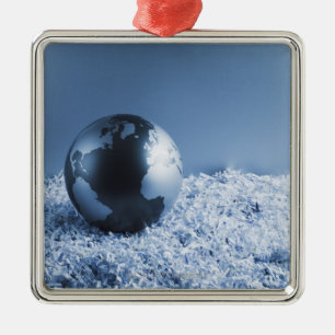 Metal globe on shredded paper tree decoration