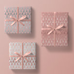 Metallic Rose Gold Platinum Silver Christmas Trees Wrapping Paper Sheet<br><div class="desc">This assortment of holiday wrapping paper sheets features simulated metallic glitter faux foil ornate christmas pine tree silhouettes in rose gold and platinum silver scattered over a beautiful solid tones of mauve,  rose quartz pink,  and platinum grey</div>