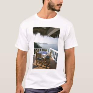Mexico, Guerrero, Zihuatanejo. Cafe Table over T-Shirt
