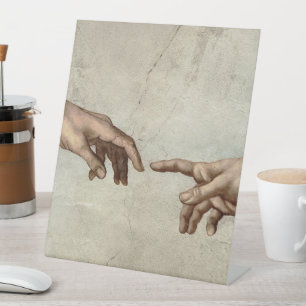Michaelangelo hands creation adam god pedestal sign