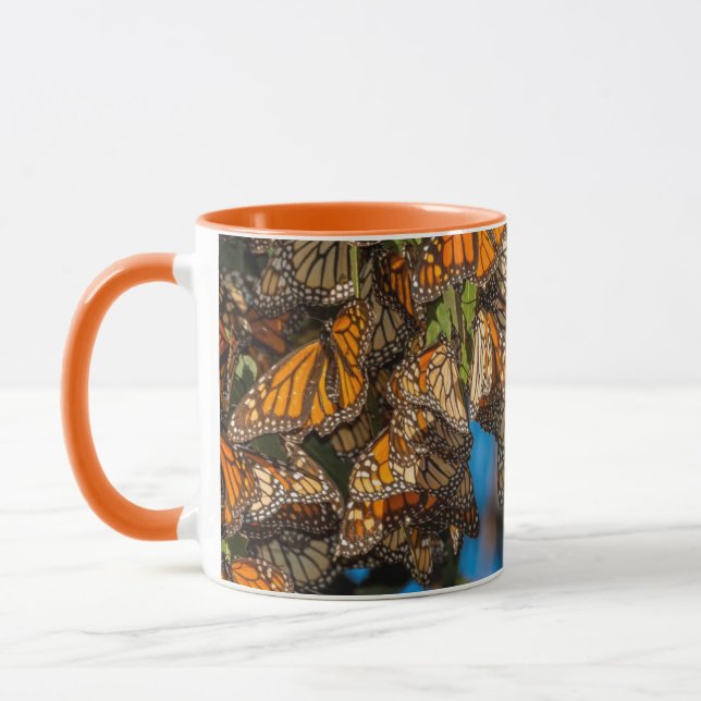 Migrating monarch butterflies cling to leaves mug (Left)