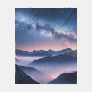 Milky Way over mountains in fog at night in summer Fleece Blanket