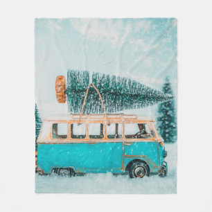 Miniature antique car carrying christmas tree on r fleece blanket