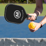 Minimal Classic Monogram Black Pickleball Paddle<br><div class="desc">Masculine modern design features an easy-to-use template for a single letter and name in stylish classic professional white lettering on a modern monogram medallion. The design repeats on the reverse side. Perfect pickleball gift for him.</div>