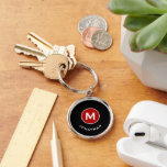 Minimal Classic Monogram Black Red Key Ring<br><div class="desc">Minimal monogrammed round keychain feature a black background with your initial in a red monogram medallion with and name in classic block typography in white for a simple classic professional look.</div>