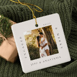 Minimal Modern Engaged & Merry 2 Photo Engagement Ceramic Ornament<br><div class="desc">Minimal and modern simple photo keepsake photo ornament to commemorate your first Christmas engaged. The design features a simple minimal design with a square photo design to display your special engagement photo. "Engaged & Merry", year and couple's name displayed in a simple modern design around the photo. Two photo ornament...</div>