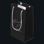 Minimalist Black Script Bridal Shower Thank You Small Gift Bag<br><div class="desc">This bridal shower gift bag features soft script lettering on a classic black background for a timeless, elevated look. The minimalist design pairs beautifully with modern, formal, or monochrome bridal shower themes while keeping the focus on thoughtful presentation. A polished finishing touch that complements elegant bridal shower décor without feeling...</div>
