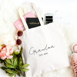 Minimalist Grandma EST 2025  | Personalised Gift Tote Bag<br><div class="desc">tote bag. Featuring clean modern script on a neutral background, this bag is both fashionable and functional — perfect for daily errands, baby visits, or carrying essentials in style. Customise the “EST” year to mark her new role and make it a heartfelt gift for baby announcements, Mother’s Day, or a...</div>