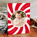 Minimalist Red and White Peppermint Swirl Photo Holiday Card<br><div class="desc">Modern holiday card featuring your photo encircled by a white frame with a red and white peppermint swirl background. The phrase "Merry and Bright" is displayed in curved white lettering. Personalise the peppermint swirl Christmas card with your family name. The back of the card features a red background with subtle...</div>