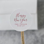 Minimalist Red Happy New Year Holiday Gift Classic Round Sticker<br><div class="desc">These minimalist red Happy New Year holiday gift stickers are perfect for a simple holiday present or holiday card. The design features classic red and white typography paired with a rustic yet elegant script font with hand lettered style. Personalise the stickers with your name.</div>