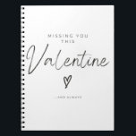 Missing You This Valentine Script Heart Notebook<br><div class="desc">This minimalist Valentine’s design features the heartfelt message: “MISSING YOU THIS Valentine …AND ALWAYS” with a small heart symbol in the centre. The word Valentine is written in elegant cursive script, while the rest of the text appears in a clean sans-serif font. The black text on a white background creates...</div>