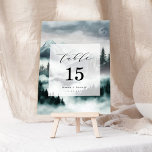 Misty Mountain Pine Forest Wedding Table Number<br><div class="desc">This elegant designs beautifully showcases a moody mountain landscape, with misty pine forests and soft fog creating an atmosphere of mystery and romance. Ideal for nature-loving couples, it blends rustic charm with elegant design. The cool-toned hues and captivating scenery evoke a sense of calm and intimacy, while the refined typography...</div>