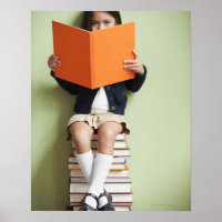 Mixed race girl sitting on stack of books