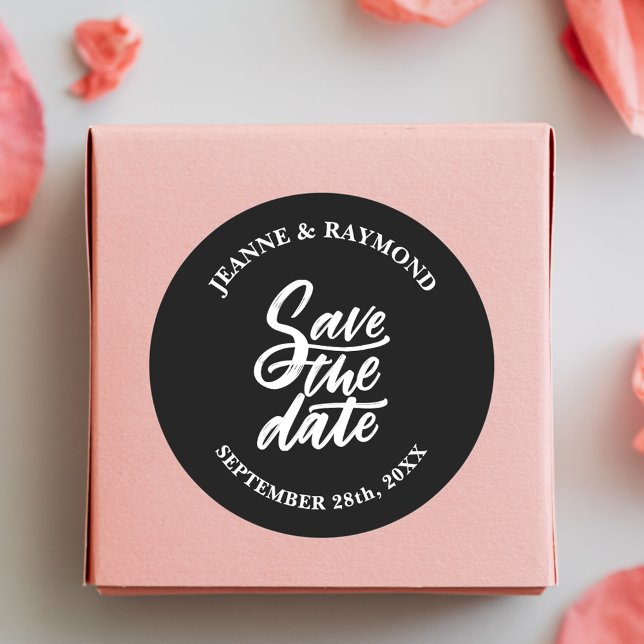 Modern Black Brush Lettered Wedding Save the Date Classic Round Sticker (Modern black brush lettered sticker adds stylish charm to wedding save the date mail.)