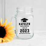 Modern Black Custom Graduation Party Mason Jar<br><div class="desc">Graduation mason jars feature a modern personalised design for the graduate. Includes a simple stylish typography design of their first and last name, class year, school name, and a grad cap motif. Two sided design includes black custom text. Versatile graduation party decor item can be used as a glass, vase,...</div>