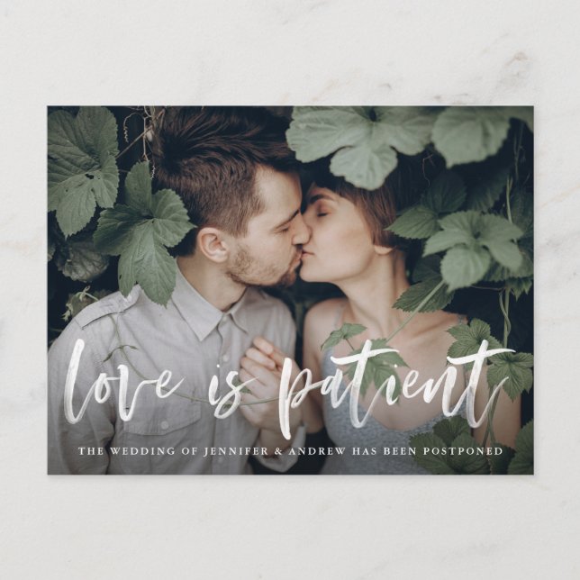 Modern Brush Script Love is Patient Postponement Announcement Postcard (Front)