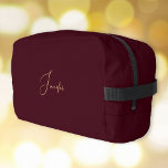 Modern Burgundy Gold Monogram Gym Travel Cosmetic Dopp Kit<br><div class="desc">Create your own custom, personalised, beautiful modern elegant faux gold script / typography monogram monogrammed, durable Polyester Poplin, sturdy polyester fabric mens womens kids solid plain dark burgundy brown cosmetic makeup toiletry organiser golf beach accessory gym travel dopp kit bag pouch with a zippered closure, two interior mesh pockets -...</div>