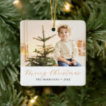 Modern Calligraphy Merry Christmas Photo Ceramic Ornament<br><div class="desc">Modern elegant minimal holiday ornament features one large of your favourite photo,  festive dusty orange script calligraphy "Merry Christmas" with classic serif lettering in black.</div>