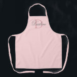 Modern Chic Script Blush Pink Monogram Name Apron<br><div class="desc">Modern Chic Script Blush Pink Monogram Name Apron is designed with customisable pastel pink background and dark dusty rose monogram initial on the centre.  Personalised with name in classy light grey calligraphy script lettering in white.
CLICK PERSONALIZE TEMPLATE OPTION AND ENTER MONOGRAM AND NAME.</div>