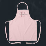 Modern Chic Script Blush Pink Monogram Name Apron<br><div class="desc">Modern Chic Script Blush Pink Monogram Name Apron is designed with customisable pastel pink background and dark dusty rose monogram initial on the centre.  Personalised with name in classy light grey calligraphy script lettering in white.
CLICK PERSONALIZE TEMPLATE OPTION AND ENTER MONOGRAM AND NAME.</div>