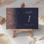 Modern Dark Blue Rose Gold Glitter Edge Wedding Table Number<br><div class="desc">The left-hand edge of this elegant modern wedding table number features a rose gold faux glitter design. The customisable text combines pale rose coloured handwriting,  copperplate and italic fonts on a dark blue background.</div>