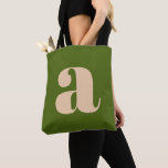 Modern Earthy Green Bold Retro Monogram Initial Tote Bag<br><div class="desc">A stylish and contemporary tote bag featuring a rich olive green background with a bold beige lowercase letter in modern typography. Designed for everyday use, this versatile bag is perfect for shopping, work, or as a fashionable accessory. Its minimalist yet eye-catching design makes it an ideal gift for typography lovers...</div>
