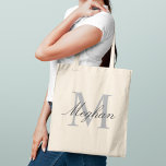 Modern Elegant Grey Monogram Initial Name Tote Bag<br><div class="desc">A timeless classic,  this tote features a large grey monogram initial paired with a personalised name in sophisticated dark script. The neutral palette makes it an endlessly versatile monogram gift — perfect for bridesmaids,  birthdays,  teachers,  or as a polished everyday carry. Initial and name are fully customisable.</div>