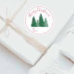 Modern Elegant Script Pine Trees Christmas Gift Classic Round Sticker<br><div class="desc">Beautiful Christmas gift round sticker featuring green pine trees and festive red elegant script typography in a round red frame. Add your Merry Christmas on the top and ´´to/from´´ on the bottom. You can customise it easily in a foreign language through the ´´Personalise´´ button. It will look beautiful on the...</div>