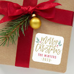 Modern Gold Script Merry Christmas Custom Square Sticker<br><div class="desc">Stylish Merry Christmas holiday favour sticker features antique gold script writing and accents of green branches with holly leaves and red berries. Personalise with custom name / family and year text. The white background colour can be modified.</div>