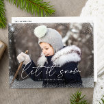 Modern Let It Snow Script Photo Holiday Postcard<br><div class="desc">Wish friends and family a Merry Christmas with a cute holiday photo postcard! The postcard features your horizontal photo with subtle snow flurries bordering the card. "Let it Snow" is displayed in a white, trendy calligraphy script with your family's name below. The simple holiday postcard reverses to display your return...</div>