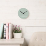 Modern Minimal Sage Green Personalised Name Round Clock<br><div class="desc">Add a touch of timeless elegance to your space with our Modern Minimal Sage Green Personalised Wall Clock. Crafted with simplicity and sophistication in mind,  this sleek timepiece is customisable to reflect your unique style. Perfect for any room,  it effortlessly blends contemporary design with understated charm.</div>