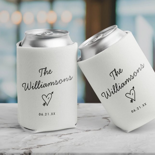 Modern Minimalist Wedding Simple Last Name Can Cooler (Two white can coolers with the text The Williams and date and a heart with arrow, minimalist design)