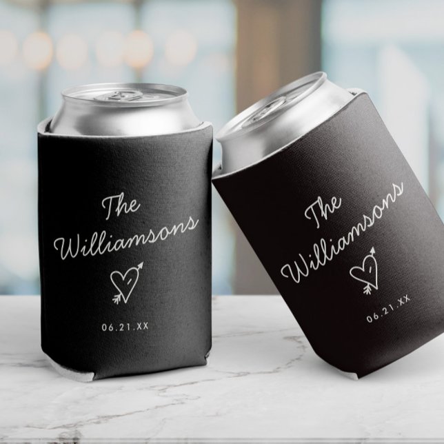 Modern Minimalist Wedding Simple Last Name Can Cooler (Black can coolers with custom date and name, as well as a cupids heart illustration, minimalist cool)