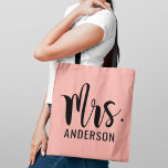 Modern Mrs Pink Black Script Wedding Monogram<br><div class="desc">Custom wedding tote bag features a bold and modern Mrs script monogram of the bride's married last name in stylish black text with blush pink background. Two-sided design.</div>