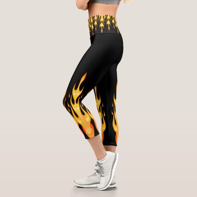 Modern orange yellow fire flames on black capri leggings (Left)
