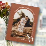 Modern Photo Arch Terracotta Wedding Planner<br><div class="desc">An elegant spiral-bound wedding planner calendar features your photo in a unique arched layout on a terracotta background, your names joined with a large white ampersand at the bottom and your wedding date arched at the top. Change the colour of the book on the front and back to match your...</div>