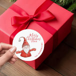 Modern Red and White Fun Gnome Merry Christmas Classic Round Sticker<br><div class="desc">These cute personalised Christmas stickers with a Merry Christmas saying and a cheerful gnome in red apparel on a white background were designed for Xmas mailing seals or favour gifts labels. The template text makes it easy to type your Family name and a year.</div>