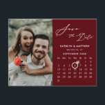 Modern Red Elegant Script Photo Save the Date Announcement Postcard<br><div class="desc">Modern Maroon Red | Burgundy Elegant Script ‘Save the Date’ Announcement Postcard featuring Custom Calendar with a beautiful Photo. Let your family, friends and colleagues know that you have set a date for your wedding celebration with this elegant card. To move the Ring marker > click blue ‘Personalise’ > click...</div>