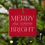 Modern Red Merry and Bright Photo Ceramic Ornament<br><div class="desc">Modern holiday ornament featuring "Merry and Bright" in white lettering and red background with subtle white dots. Personalise the front of the red Christmas ornament with your family name and year displayed in white lettering. The ornament reverses to display your square photo framed in white.</div>
