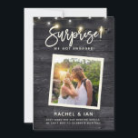 Modern Rustic Snapshot Surprise Engagement Photo S Save The Date<br><div class="desc">Modern rustic fun photo engagement announcement with your photo in a square frame on a dark wooden backdrop with string lights and a hand lettered script reading SURPRISE! We got engaged! Space for details like date for a save the date,  wedding website etc on the front and back.</div>